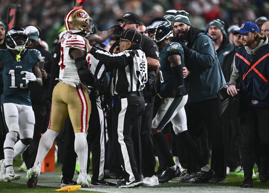 PHILADELPHIA, PA - DECEMBER 03: San Francisco 49ers Linebacker Dre Greenlaw (57) strikes Philadelphia Eagles Chief Security Officer Dom DiSandro in the second half during the game between the San Francisco 49ers and Philadelphia Eagles on December 03, 2023 at Lincoln Financial Field in Philadelphia, PA. (Photo by Kyle Ross/Icon Sportswire via Getty Images)