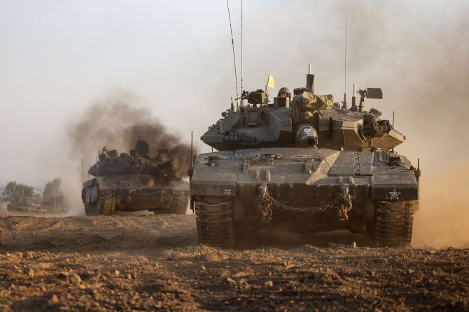 Israeli military tanks roll near the border with the Gaza on December 3. 