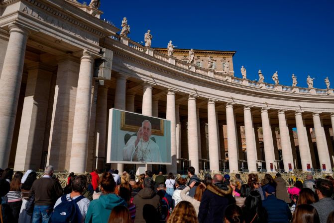 Pope Francis appears on a giant monitor set up in the Vatican's St. Peter's Square in December 2023. Francis led his customary Angelus prayer from his home rather than from the window of the Vatican's Apostolic Palace overlooking the square. He was suffering from what he described as "severe bronchitis," and he was avoiding being exposed to the cold weather.