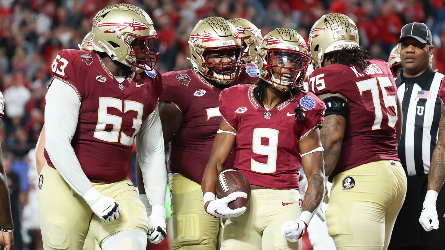 CHARLOTTE, NORTH CAROLINA - DECEMBER 2: Lawrance Toafili #9 of the Florida State Seminoles celebrates with the team after scoring a touchdown in the third quarter against the Louisville Cardinals during the ACC Championship at Bank of America Stadium on December 2, 2023 in Charlotte, North Carolina. (Photo by Isaiah Vazquez/Getty Images)