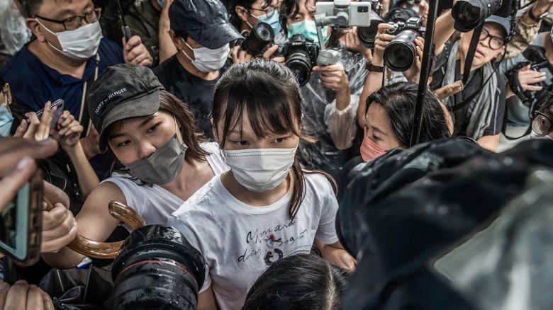 Agnes Chow (C) walks through the media pack after being released from the Tai Lam Correctional Institution in Hong Kong, China, on 12 June, 2021.
