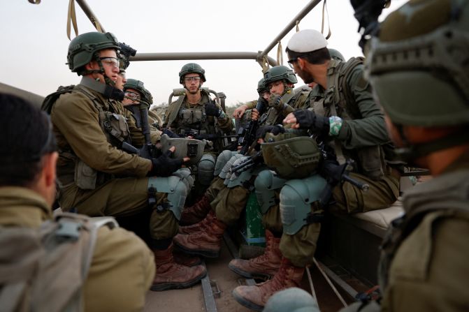 Israeli soldiers sit in a military vehicle near Israel's border with Gaza, in southern Israel, on December 4.