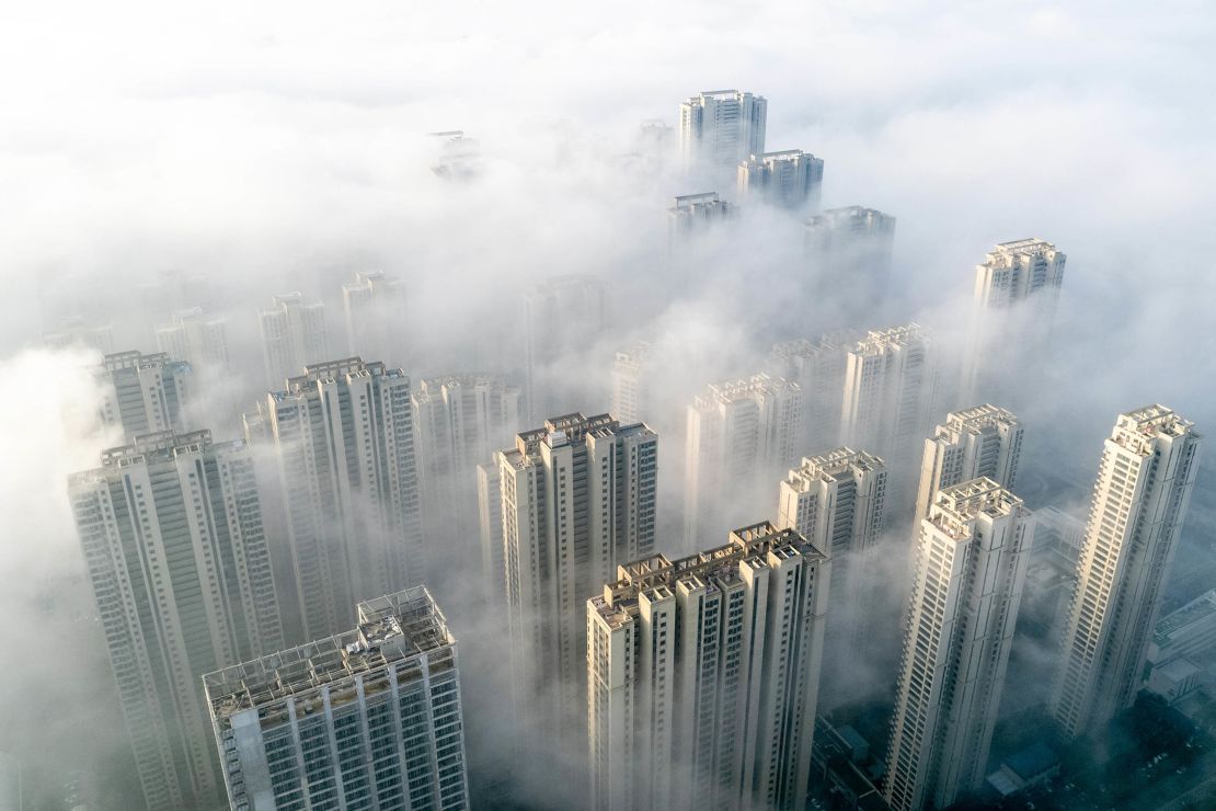 TOPSHOT - This aerial photo taken on November 27, 2023 shows fog over residential buildings in Wuhan, in China's central Hubei province. (Photo by AFP) / China OUT (Photo by STR/AFP via Getty Images)