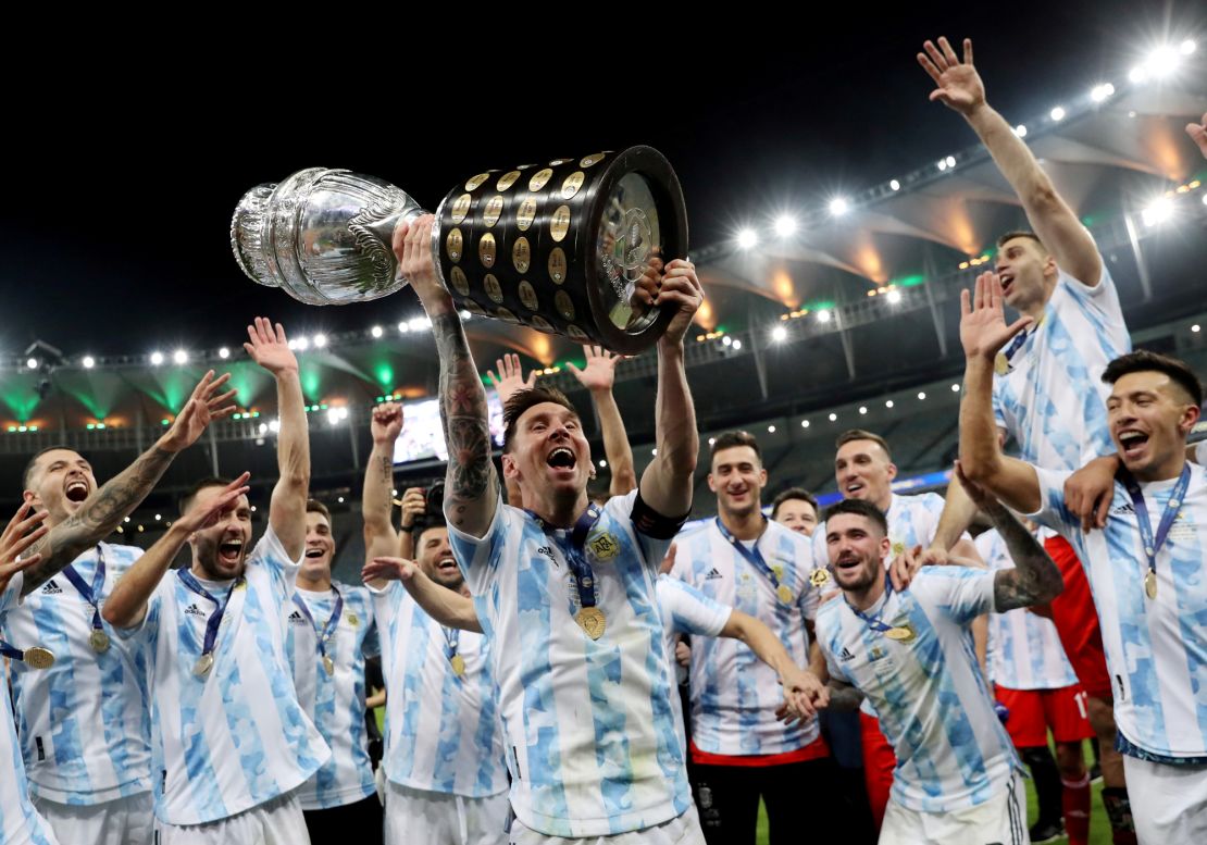 Soccer Football - Copa America  2021 - Final - Brazil v Argentina - Estadio Maracana, Rio de Janeiro, Brazil - July 10, 2021 Argentina's Lionel Messi and teammates celebrate winning the Copa America with the trophy REUTERS/Amanda Perobelli/File Photo     TPX IMAGES OF THE DAY SEARCH 