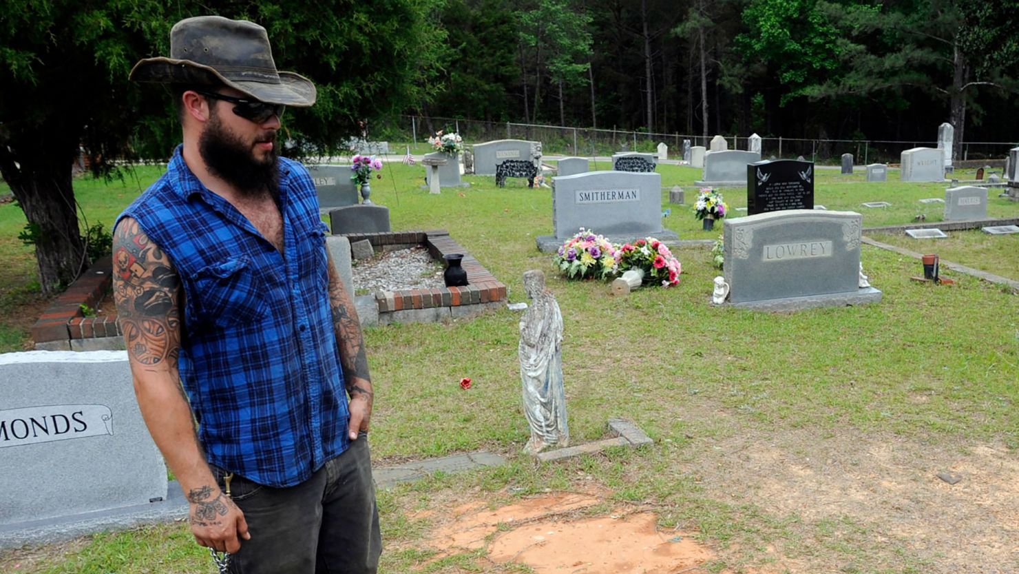 FILE - Tyler Goodson of the hit podcast "S-Town" stands at the grave in Green Pond, Ala., of his late friend John B. McLemore, who is also featured in the show, on May 3, 2017. Goodson, a man featured in the podcast which chronicled events in a rural Alabama community, died after being shot by police during a Sunday standoff, Dec. 3, 2023, a state agency said. (AP Photo/Jay Reeves, File)