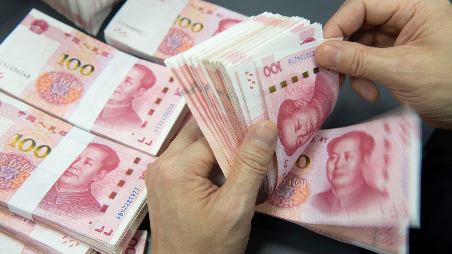 A bank employee is counting Chinese yuan in Haian, Jiangsu province, China, on June 20, 2023.