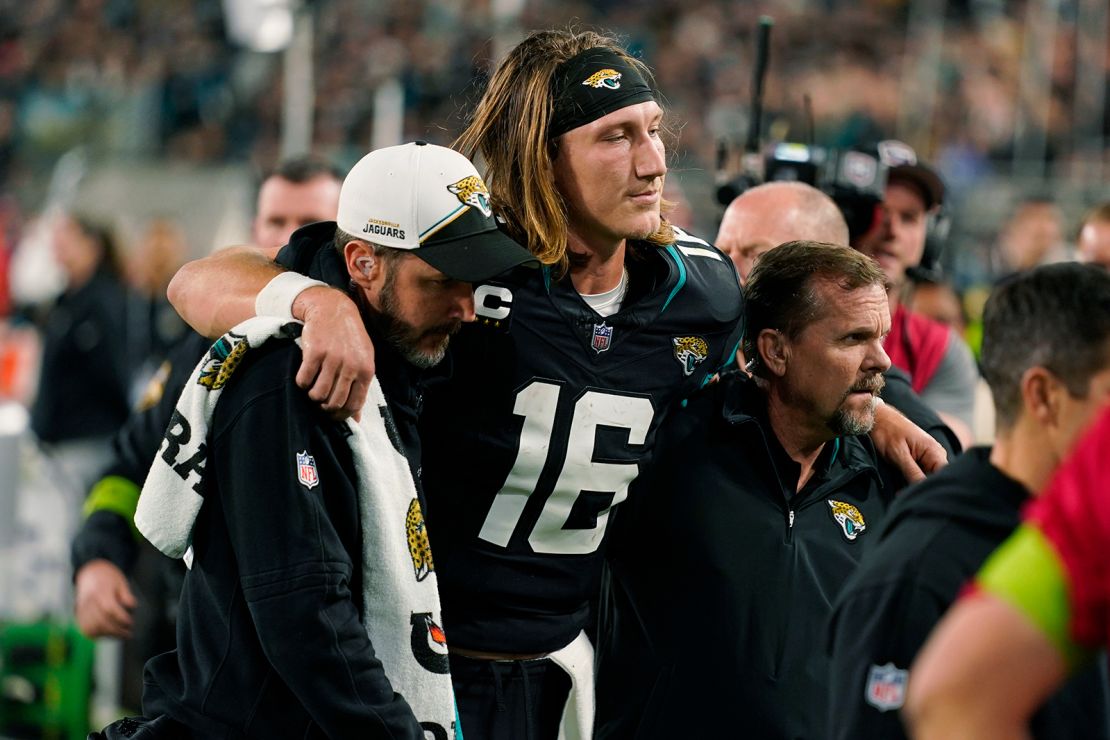 Jacksonville Jaguars quarterback Trevor Lawrence (16) is assisted off the field after he was injured during the second half of an NFL football game against the Cincinnati Bengals, Monday, Dec. 4, 2023, in Jacksonville, Fla.