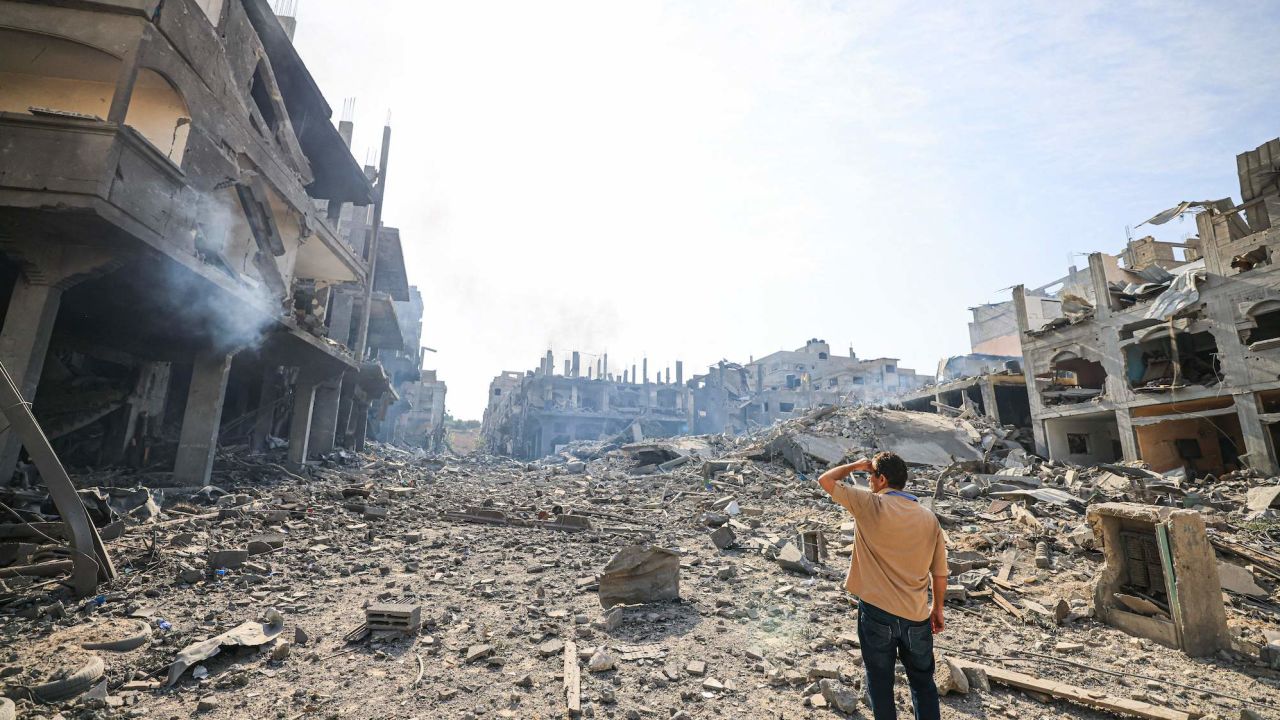 TOPSHOT - A man looks at the destruction in a ravaged neighbourhood in the Gaza Strip Jabalia refugee camp on October 11, 2023, following overnight Israeli airstrikes amid continuing battles between Israel and the Hamas movement. The death toll from five days of ferocious fighting between Hamas and Israel rose sharply overnight as Israel kept up its bombardment of Gaza after recovering the dead from the last communities near the border where Palestinian militants had been holed up. (Photo by MAHMUD HAMS / AFP) (Photo by MAHMUD HAMS/AFP via Getty Images)