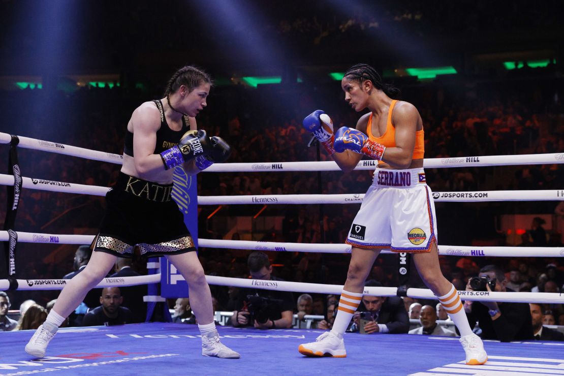 NEW YORK, NEW YORK - APRIL 30: Katie Taylor of Ireland (black trunks) trades punches with Amanda Serrano of Puerto Rico (white trunks) for the World Lightweight Title fight at Madison Square Garden on April 30, 2022 in New York, New York. This bout marks the first women's boxing fight to headline Madison Square Garden in the venue's history. Taylor defeated Serrano on a judges decision. (Photo by Sarah Stier/Getty Images)