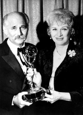 Lear accepts an Emmy from Eve Arden in 1971. "All in the Family" was named best comedy series.