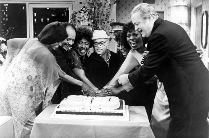 Lear cuts a cake with the cast of "The Jeffersons" as they celebrated their 200th episode in 1983. From left are Marla Gibbs, Sherman Hemsley, Isabel Sanford, Lear, Ned Wertimer, Berlinda Tolbert, Roxie Roker and Franklin Cover.