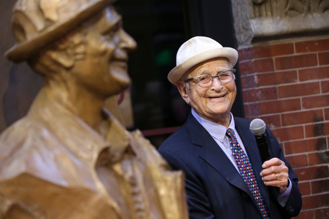 Lear looks at a statue of him that was unveiled at Emerson College in Boston in 2018. He attended the school before dropping out to join the military in 1942.