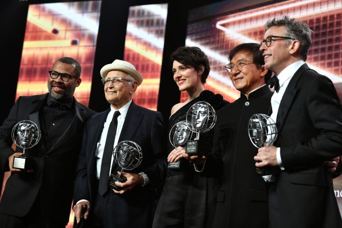 From left, Jordan Peele, Lear, Phoebe Waller-Bridge, Jackie Chan and Steve Coogan pose with awards they won at the Brittania Awards in 2019.