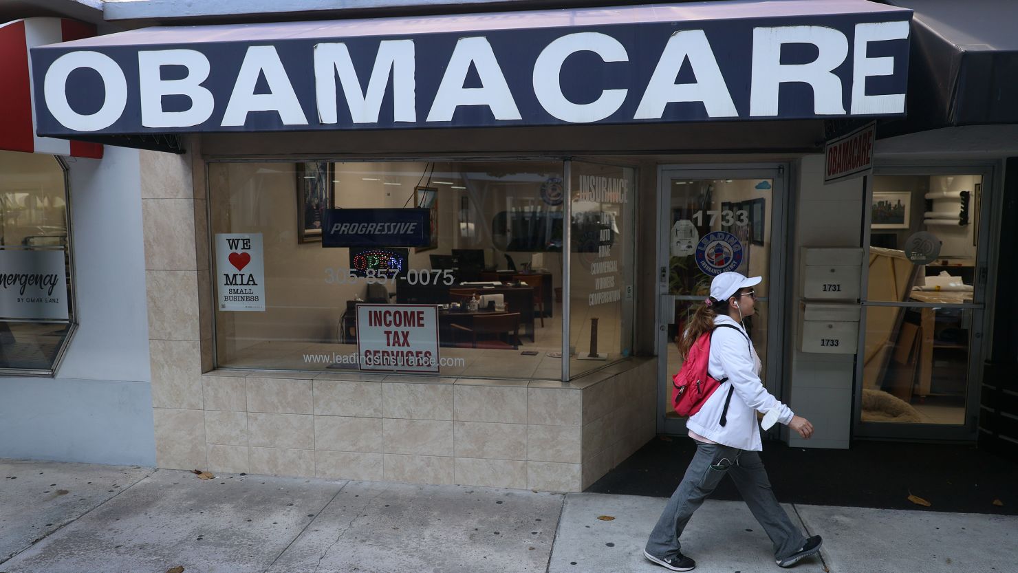 MIAMI, FLORIDA - JANUARY 28: A pedestrian walks past the Leading Insurance Agency, which offers plans under the Affordable Care Act (also known as Obamacare) on January 28, 2021 in Miami, Florida. President Joe Biden signed an executive order to reopen the Affordable Care Act's federal insurance marketplaces from February 15 to May 15. (Photo by Joe Raedle/Getty Images)