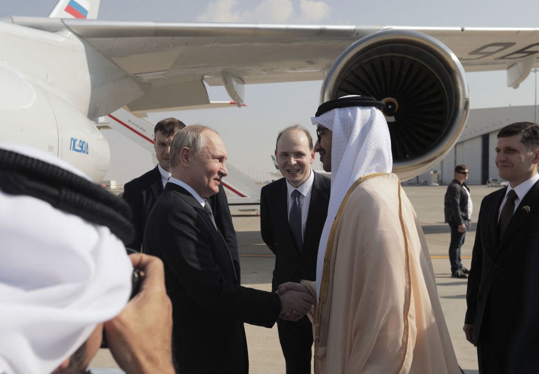 This pool photograph distributed by Russian state agency Sputnik shows Russia's President Vladimir Putin shaking hands with UAE Foreign Minister Sheikh Abdullah Bin Zayed upon arrival at the airport in Abu Dhabi on December 6, 2023. (Photo by Andrei Gordeyev / POOL / AFP)