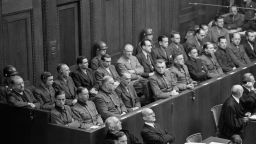 (Original Caption) Twenty-three German doctors and scientists, one a woman, sit in the dock of Nuermberg court during their arraignment on charges of inhuman experimentation on inmates of Nazi concentration camps. Left to right, front row: Karl Brandt, Siegfried Handloser, Paul Rostock, Oskar Schroeder, Karl Genzken, Karl Gebhardt, Kurt Blome, Joachim Mrugowsky, Rudolf Brandt, Helmut Poppendick, and Wolfram Sievers. Left to right, back row: Gerhard Rose, Siegfried Ruff, Victor Brack, Hans-Wolfram Romberg, Hermann Becker-Reyseng, George August Weltz, Konrad Schaefer, Waldemar Hoven, Wilhelm Beiglbock, Adolf Pororry, Herta Oberheuser, and Fritz Fischer.