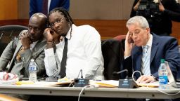 Atlanta rapper Young Thug listens in on a bench meeting between the judge and another attorney before the opening statements in his Fulton County gang and racketeering trial on Monday, November 27.