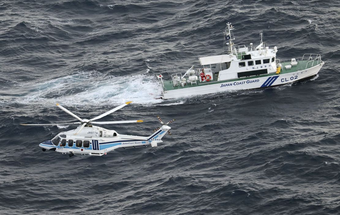 A Japan Coast Guard vessel and a helicopter conduct a search and rescue operation at the site where a U.S. military aircraft V-22 Osprey crashed into the sea off Yakushima Island, Kagoshima prefecture, Japan November 30, 2023, in this photo taken by Kyodo. Mandatory credit Kyodo via REUTERS ATTENTION EDITORS - THIS IMAGE WAS PROVIDED BY A THIRD PARTY. MANDATORY CREDIT. JAPAN OUT. NO COMMERCIAL OR EDITORIAL SALES IN JAPAN