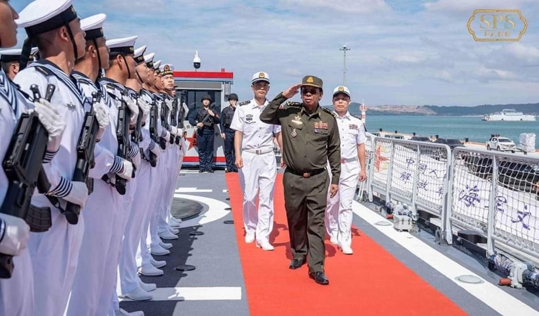 Tea Banh, former Cambodian Defense Minister, reviews Chinese naval officers on board a Chinese corvette at the Ream Naval Base.