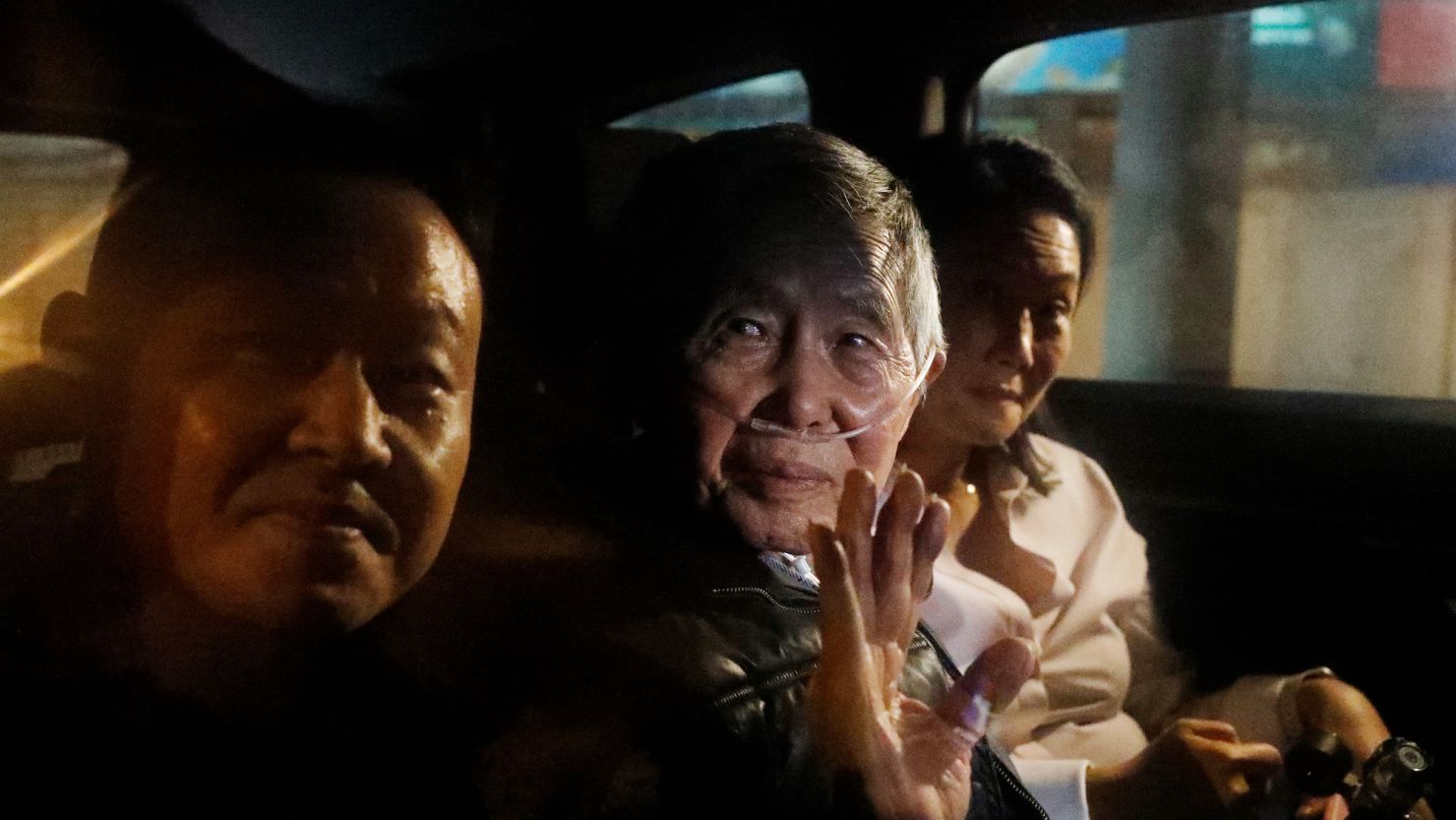 LIMA, PERU - DECEMBER 06: Former president of Peru Alberto Fujimori exits in a car with son Kenji Fujimori (L) and daughter Keiko Fujimori (R) the Barbadillo prison after being released on December 06, 2023 in Lima, Peru. On Tuesday, Peru's Constitutional Tribunal ordered the immediate release of former president Alberto Fujimori who is serving a 25 years sentence in connection with the death squad slayings of 25 Peruvians in the 1990s. This pardon request was appealed by the Inter-American Commission on Human Rights. (Photo by Mariana Bazo/Getty Images)