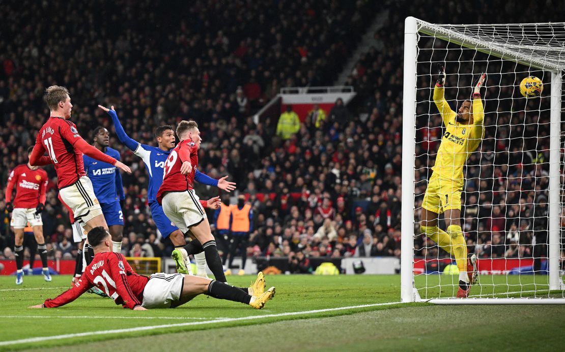 Manchester United's Scottish midfielder #39 Scott McTominay (C) watches his header pass Chelsea's Spanish goalkeeper #01 Robert Sanchez to score the team's second goal during the English Premier League football match between Manchester United and Chelsea at Old Trafford in Manchester, north west England, on December 6, 2023. (Photo by Oli SCARFF / AFP) / RESTRICTED TO EDITORIAL USE. No use with unauthorized audio, video, data, fixture lists, club/league logos or 'live' services. Online in-match use limited to 120 images. An additional 40 images may be used in extra time. No video emulation. Social media in-match use limited to 120 images. An additional 40 images may be used in extra time. No use in betting publications, games or single club/league/player publications. /  (Photo by OLI SCARFF/AFP via Getty Images)