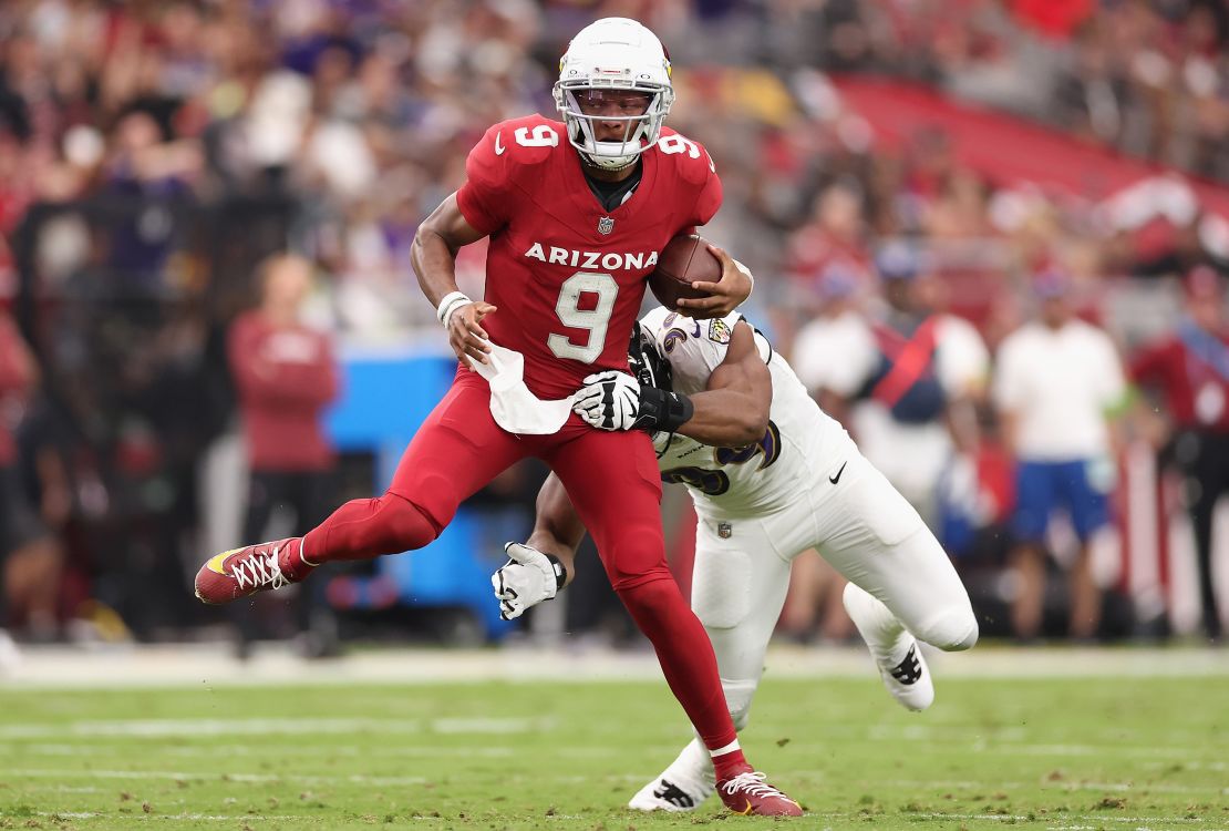 GLENDALE, ARIZONA - OCTOBER 29: Quarterback Joshua Dobbs #9 of the Arizona Cardinals avoids a tackle from linebacker Odafe Oweh #99 of the Baltimore Ravens during the NFL game at State Farm Stadium on October 29, 2023 in Glendale, Arizona. The Ravens defeated the Cardinals 31-24.  (Photo by Christian Petersen/Getty Images)
