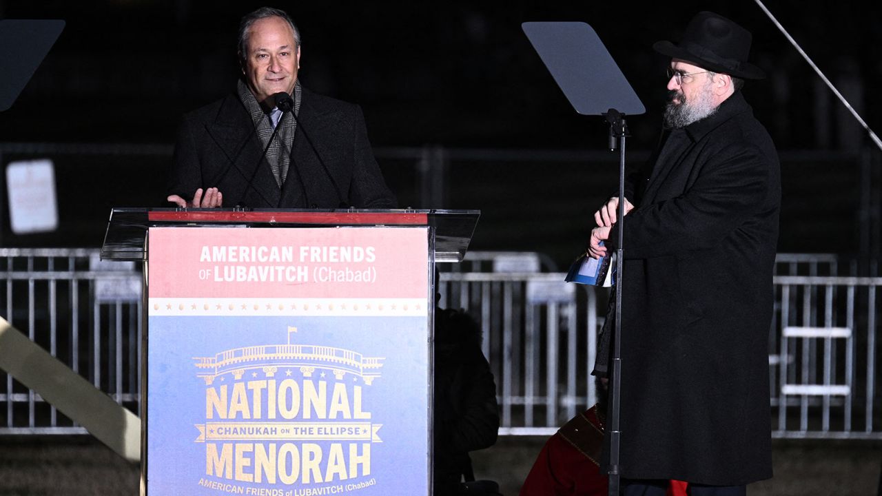 Rabbi Levi Shemtov, executive vice president of American Friends of Lubavitch (R) watches as US Second Gentleman Doug Emhoff delivers remarks during the Annual National Menorah Lighting, at the Ellipse of the White House in Washington, DC, on December 7, 2023. (Photo by Brendan SMIALOWSKI / AFP) (Photo by BRENDAN SMIALOWSKI/AFP via Getty Images)