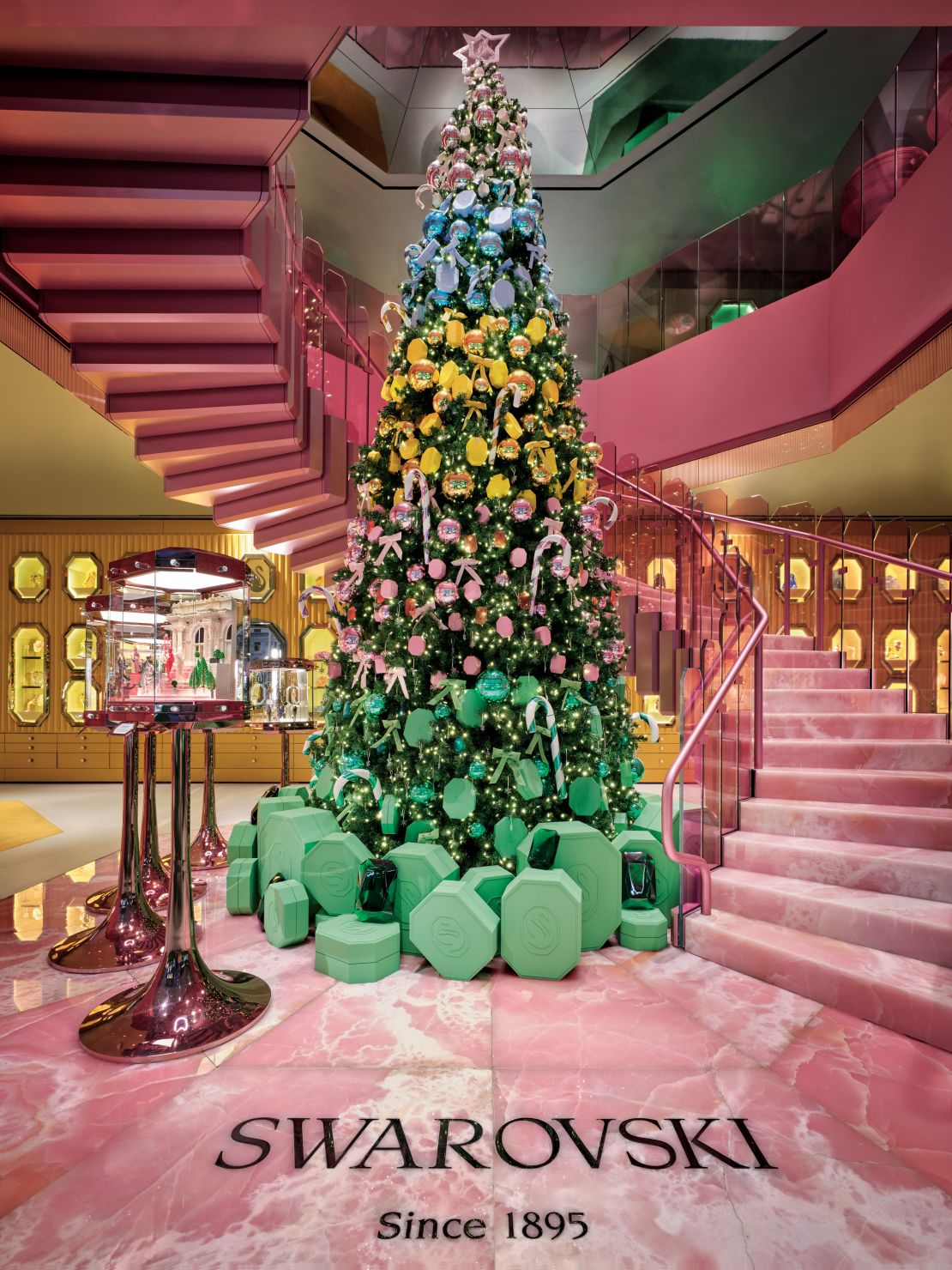 Given the season, the store currently features a large-scale Christmas tree, decorated in an ombré pattern with baubles whose color palette matches the space just so.