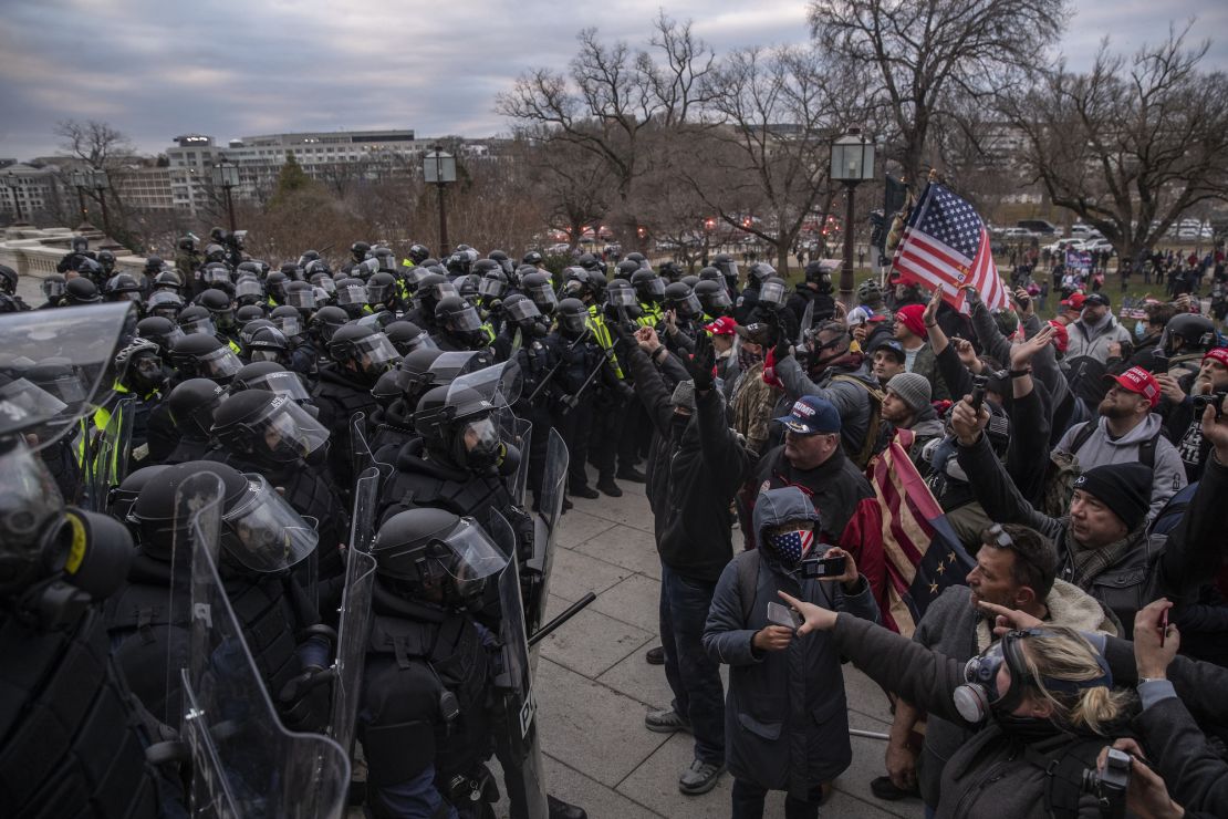 Police attempt to clear protesters trying to breach the U.S. Capital building after they earlier stormed the building in Washington, DC, U.S., on Wednesday, Jan. 6, 2021. The U.S. Capitol was placed under lockdown and Vice President Mike Pence left the floor of Congress as hundreds of protesters swarmed past barricades surrounding the building where lawmakers were debating Joe Biden's victory in the Electoral College. Photographer: Victor J. Blue/Bloomberg