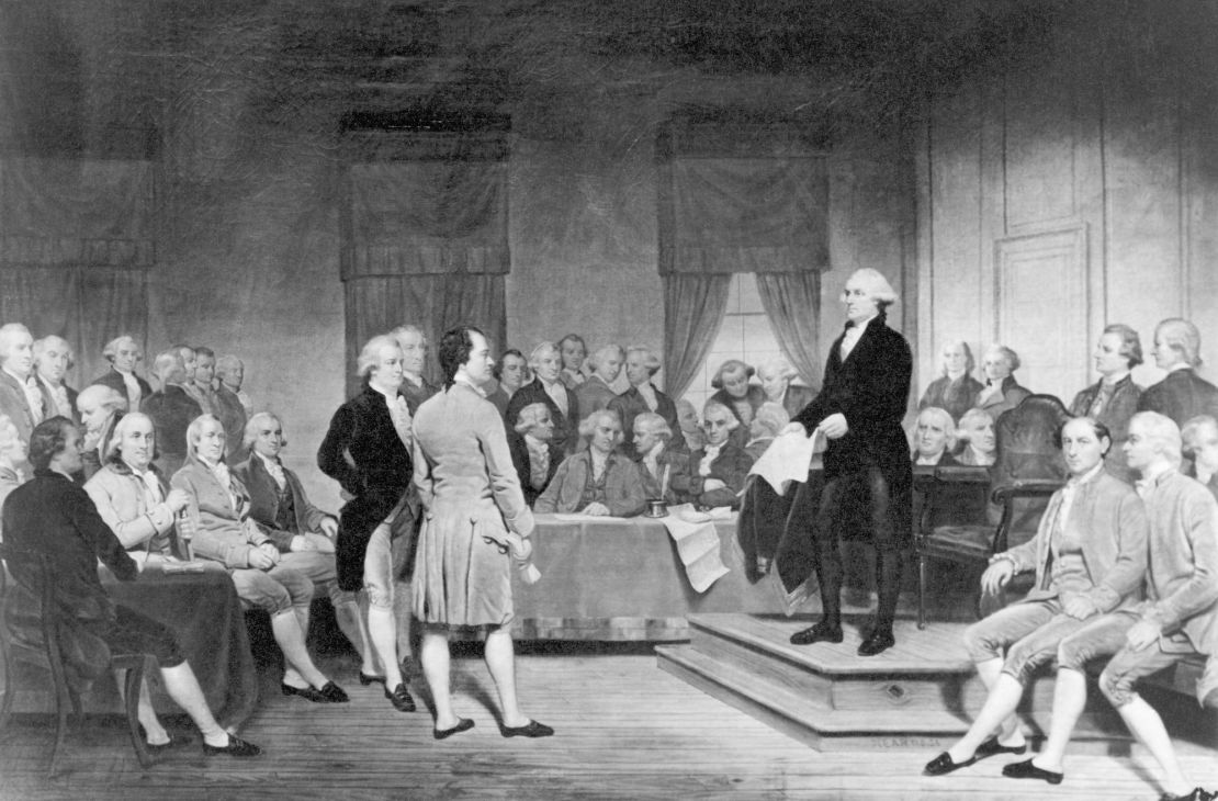 (Original Caption) The signing of the Constitution of the United States in 1787. From a painting. George Washington is standing on a platform holding a copy of the Constituution while the rest of the Founding Fathers Mill around. Undated Illustration.