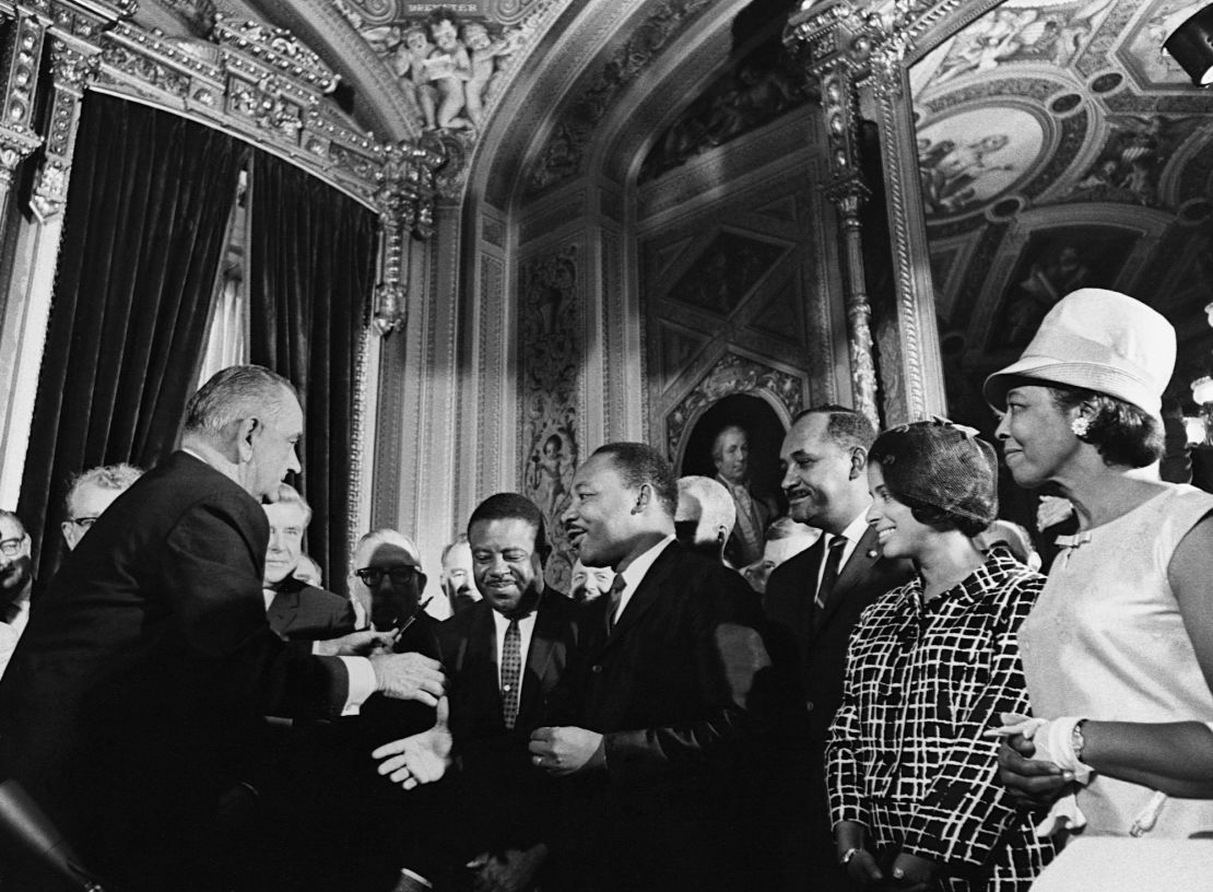 President Lyndon B. Johnson celebrates with Martin Luther King, Jr., Ralph Abernathy, and Clarence Mitchell after signing the Voting Rights bill into law. (Photo by © CORBIS/Corbis via Getty Images)