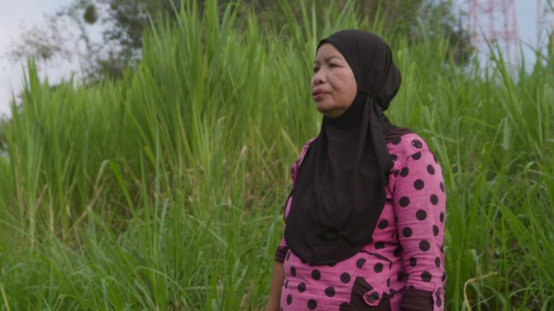 Masita, a former pepper farmer, looks over the land her family cultivated before it became a nickel mine.