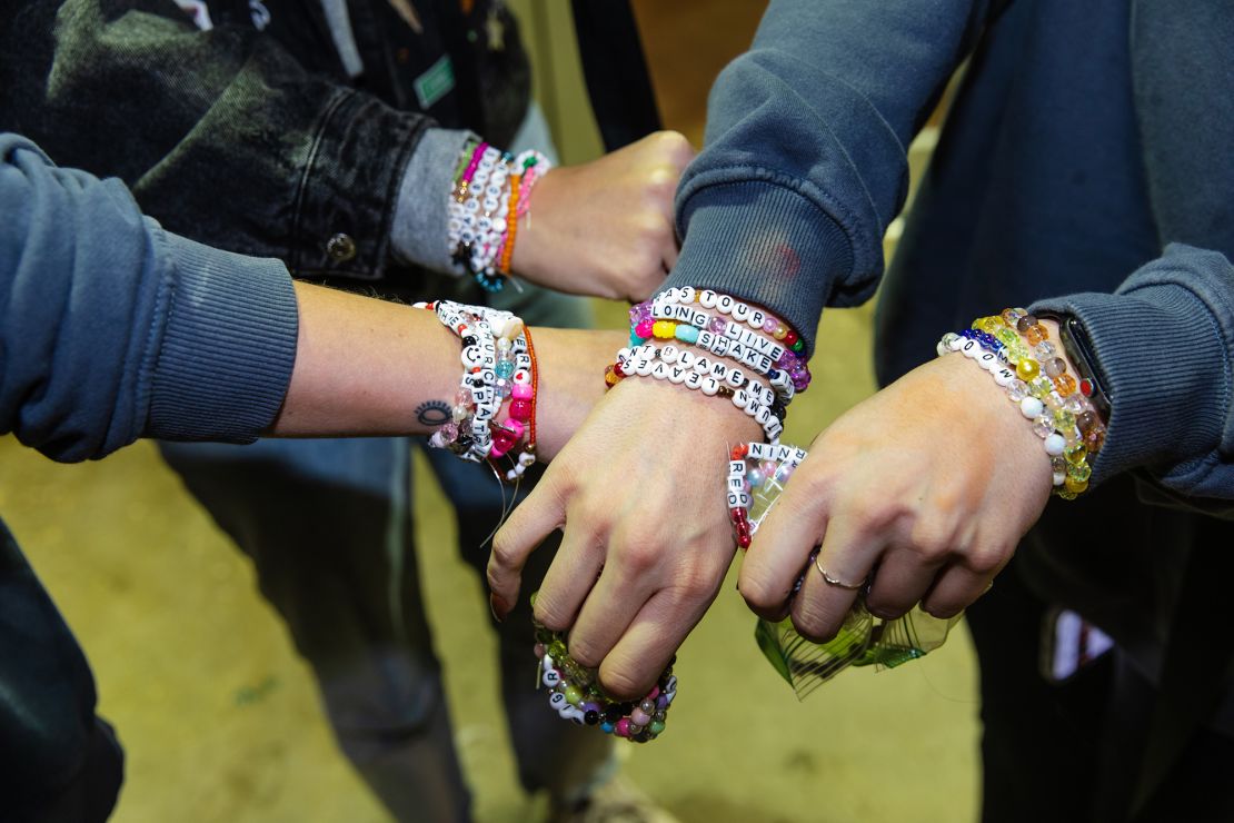 CHICAGO, ILLINOIS - OCTOBER 13: Fans exchange friendship bracelets before the opening night theatrical release of "Taylor Swift: The Eras Tour" concert movie at Regal Webster Place on October 13, 2023 in Chicago, Illinois. (Photo by Natasha Moustache/Getty Images)