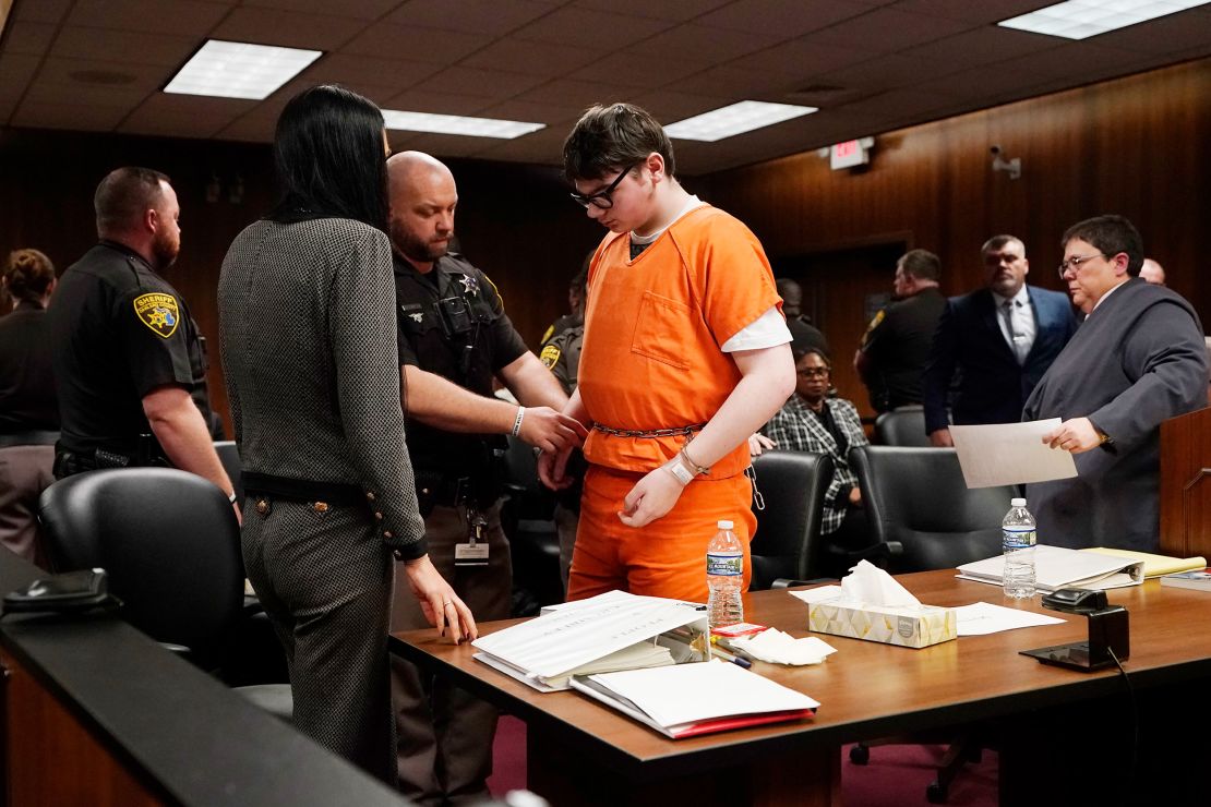 Ethan Crumbly is escorted by sheriff deputies after being sentenced, Friday, Dec. 8, 2023, in Pontiac, Mich. Crumbly sentenced to life in prison for killing four students, wounding more and terrorizing Michigan's Oxford High School in 2021. A judge Friday rejected pleas for a shorter sentence and ensured that Crumbley, 17, will not get an opportunity for parole. (AP Photo/Carlos Osorio)