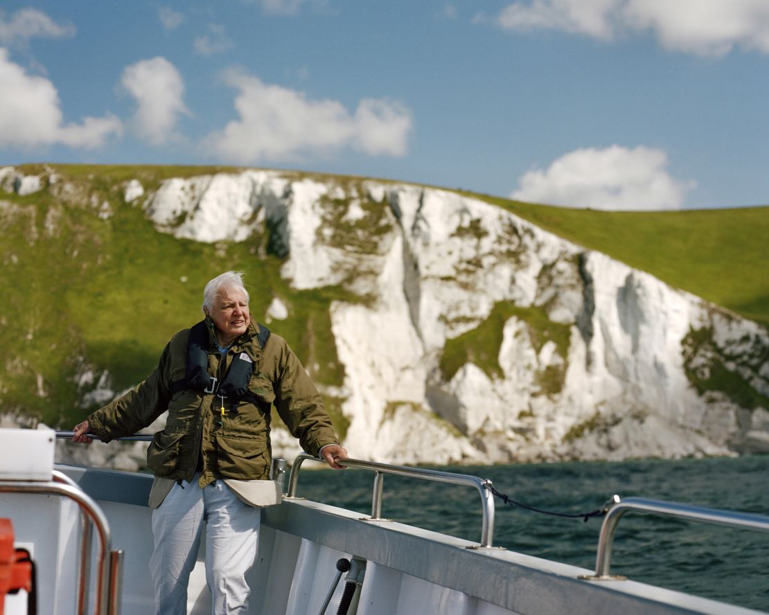 Picture Shows: Sir David Attenborough onboard a boat while filming near White Nothe cliffs, on the Jurassic Coast, Dorset, UK.