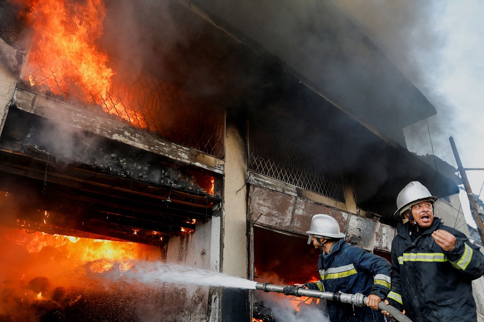 Palestinian firefighters work to extinguish a fire in a house after an Israeli strike in Khan Younis, Gaza, on December 9.