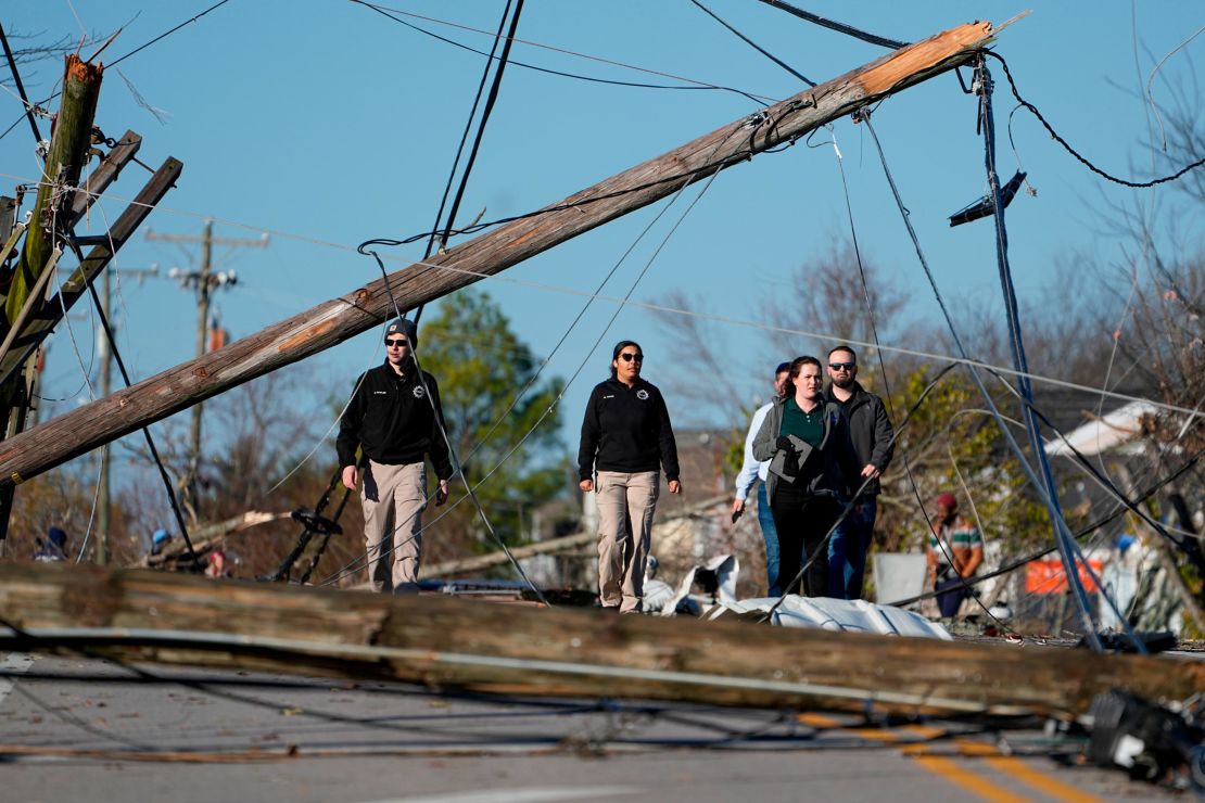Members of the Office of Emergency Management survey damage from severe weather along Nesbitt Ln. Sunday, Dec. 10, 2023 in Nashville, Tenn. Central Tennessee residents and emergency workers are continuing the cleanup from severe storms and tornadoes that hit the area.