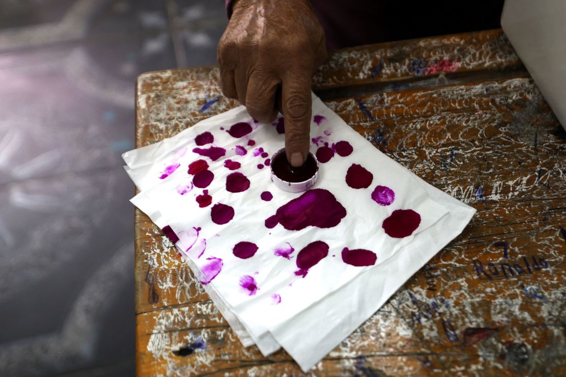 A person stains their finger on an ink pad to vote at a polling station during the first day of the presidential election in Cairo, Egypt, December 10, 2023. REUTERS/Mohamed Abd El Ghany