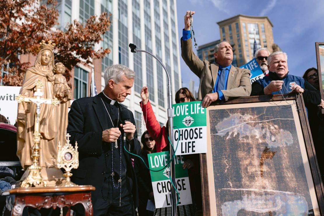 FILE -- Bishop Joseph Strickland, left, speaks to supporters outside the United States Conference of Catholic Bishops at the Marriott Waterfront hotel in Baltimore, on Wednesday, Nov. 15, 2023. Strickland, the bishop of Tyler, Texas, and a sharp critic of the pope was recently removed from his post. (Wesley Lapointe/The New York Times)