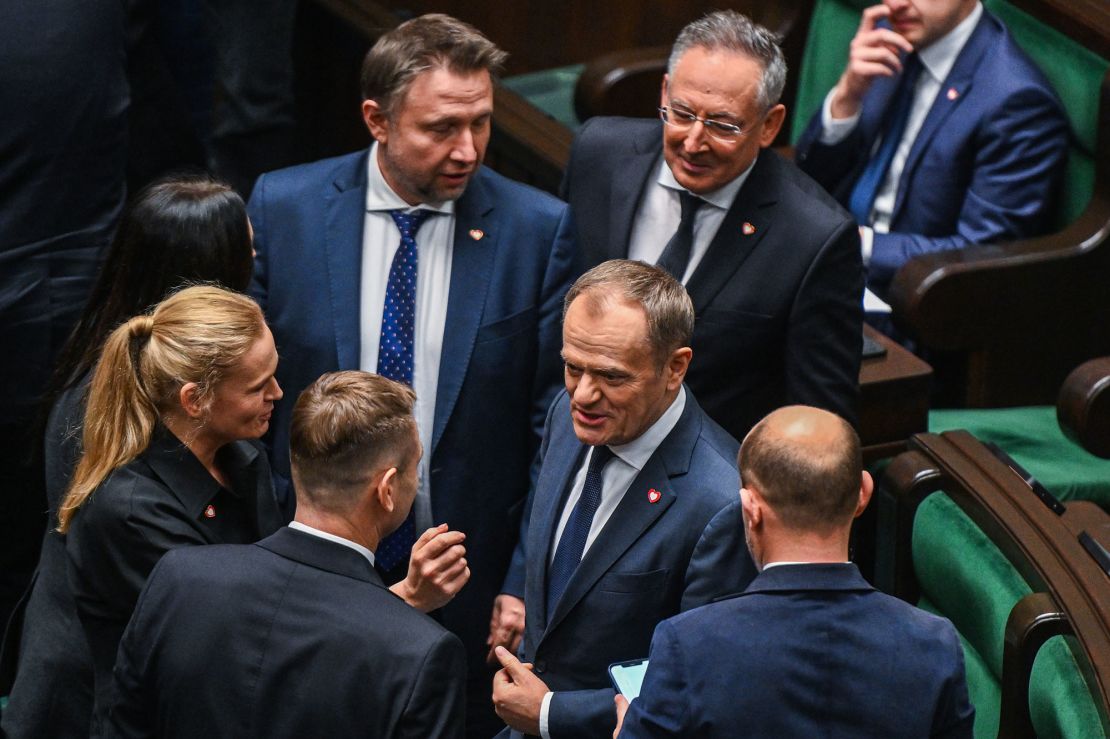 WARSAW, POLAND -- DECEMBER 11: The leader of Civic Coalition (KO), Donald Tusk stands among members of his party during a parliament session on December 11, 2023 in Warsaw, Poland. A coalition of opposition parties, with former prime minister Donald Tusk at the helm, won a majority in October's general election, ending eight years of rule by the Law and Justice (PiS) party. (Photo by Omar Marques/Getty Images)