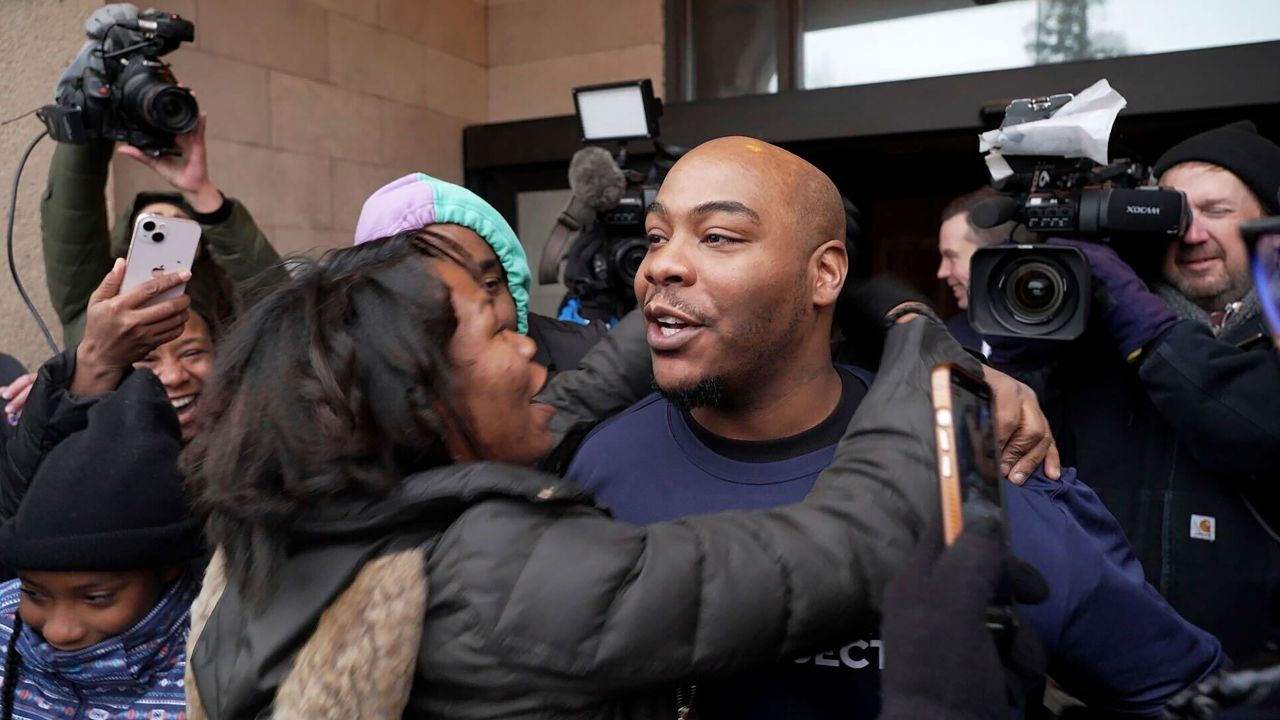 Marvin Haynes, 35, is hugged by a supporter as he walks out of the Minnesota Correctional Facility at Stillwater in Bayport, Minn. on Monday, Dec. 11, 2023, after a judge set aside his murder conviction in the 2004 killing of a man at a Minneapolis flower shop. Haynes was 16 when Randy Sherer, 55, was killed during a robbery. (AP Photo/Mark Vancleave)