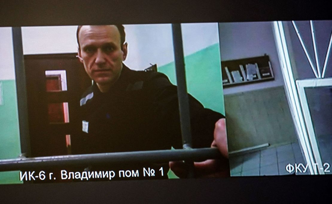 A screen shows jailed Kremlin critic Alexei Navalny as he arrives to listen to a hearing on an appeal lodged against a court decision to jail him for 19 years in a maximum security prison on extremism-linked charges, at a court in Moscow on September 26, 2023. Navalny was Russia's loudest opposition voice over the last decade and galvanised huge anti-government rallies before he was jailed in 2021 on fraud charges that his allies at home and abroad said were punitive. (Photo by TATYANA MAKEYEVA / AFP) (Photo by TATYANA MAKEYEVA/AFP via Getty Images)