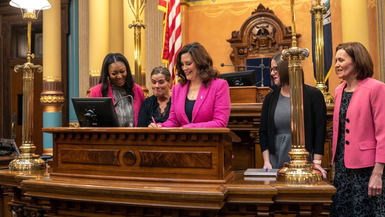 Michigan Gov. Gretchen Whitmer signs the final bill in the Reproductive Health Act on Monday, Dec. 11, 2023, at the Michigan State Capitol building in Lansing, Mich. The bill repeals Michigan's ban on insurance coverage for abortion without the purchase of a separate rider and implements other protections for doctors and patients. (Ryan Garza/Detroit Free Press via AP)