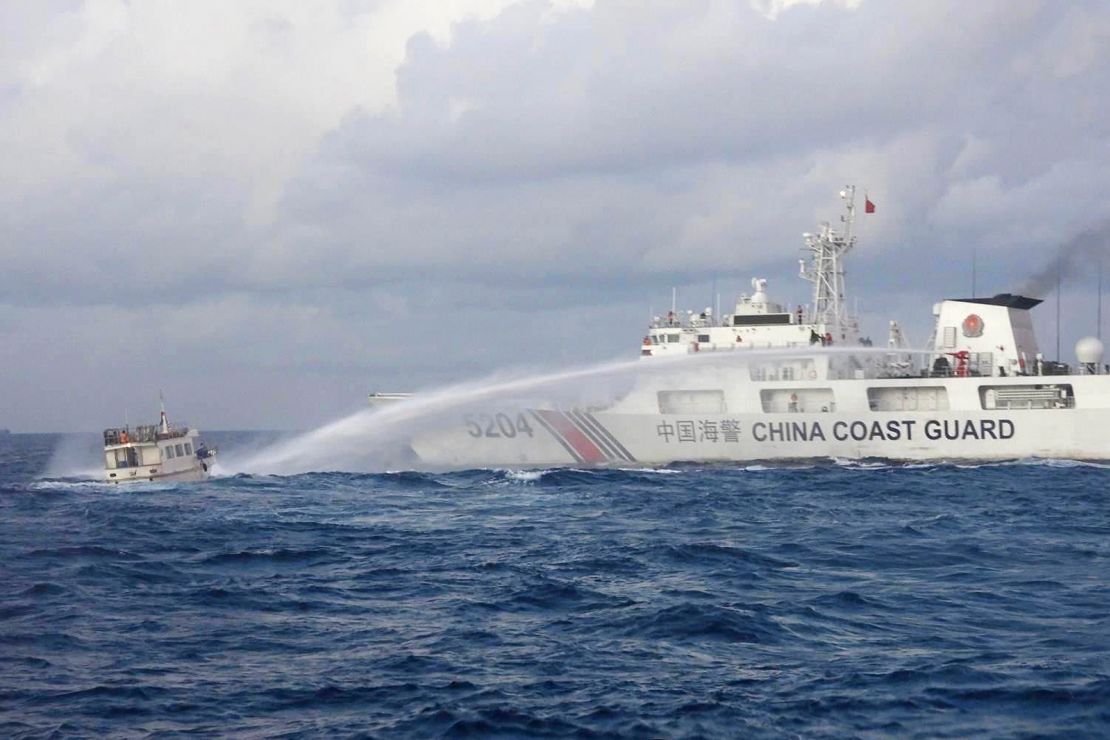 In this handout photo provided by the Philippine Coast Guard, a Chinese Coast Guard ship uses water cannons on Philippine navy-operated supply boat M/L Kalayaan as it approaches Second Thomas Shoal, locally known as Ayungin Shoal, in the disputed South China Sea on Sunday December 10, 2023.