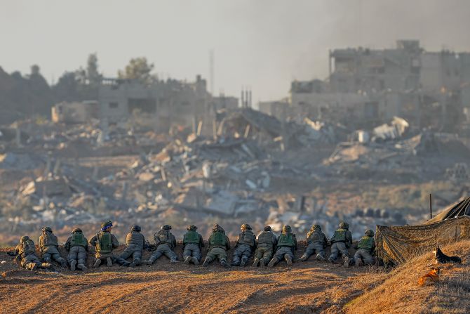 Israeli soldiers take positions in southern Israel near the Gaza border, on December 11.
