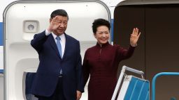 China's President Xi Jinping and his wife Peng Liyuan wave as they arrive at Noi Bai International airport in Hanoi on December 12, 2023.