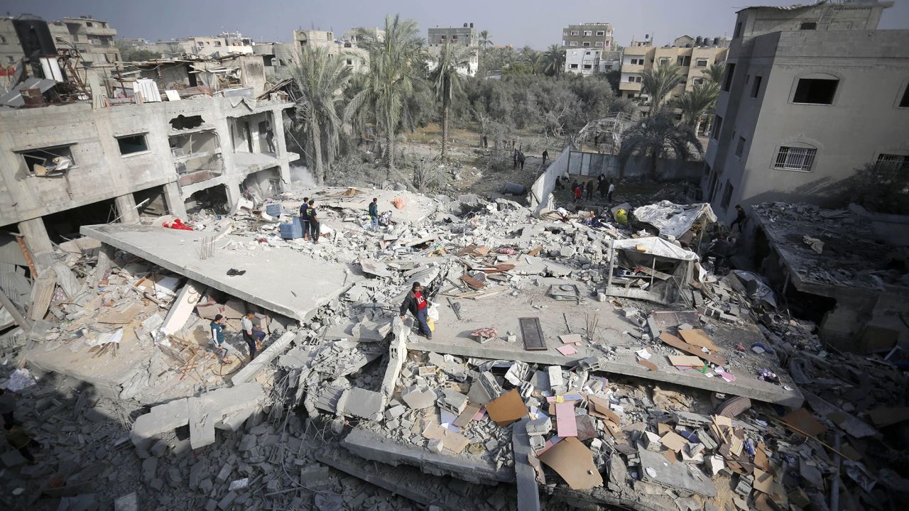 An aerial view of a destroyed residential area as Palestinians try to collect usable items under the rubbles of a building, demolished following the Israeli attacks, in Deir al-Balah, Gaza on December 12.