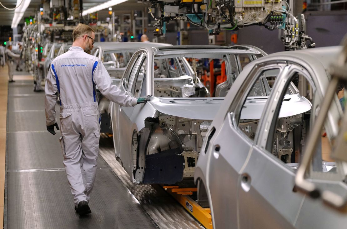 ZWICKAU, GERMANY - FEBRUARY 25: A worker runs his hand over the body of an ID.3 electric car at the Volkswagen factory on February 25, 2020 in Zwickau, Germany. Volkswagen is gradually revving up ID.3 production at the Zwickau plant from a current 110 per day to an eventual 1,500. The Zwickau plant is the first of its many factories that Volkswagen is retooling from producing combustion engine cars to only producing electric cars. Sales of the ID.3 will begin this summer.    (Photo by Sean Gallup/Getty Images)