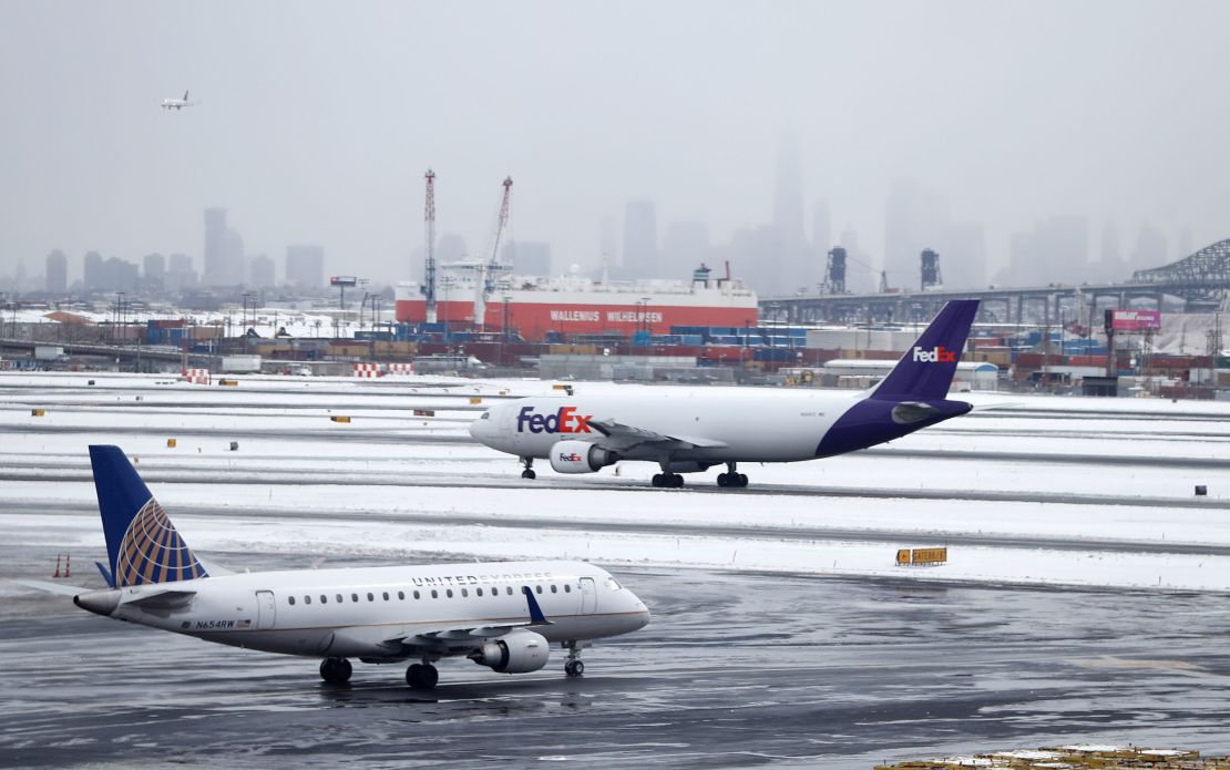 The Lower Manhattan skyline is partially obstructed by fog as planes taxi at Newark Liberty International Airport a day after a snowstorm hit the region, Wednesday, March 15, 2017, in Newark, N.J.  Plunging temperatures ushered in by the storm that plastered the Northeast turned the snow and sleet into rock-solid ice, leaving roads and sidewalks treacherous. (AP Photo/Julio Cortez)