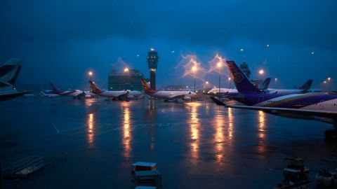 Planes parked on the tarmac as heavy rain falls on the airport in Hong Kong on Tuesday morning, July 24, 2012. Planes grounded at the financial capital's international airport were buffeted by the high winds from Typhoon Vicente early Tuesday. Passengers were told the conditions were expected to last several hours. (AP Photo/ Ng Han Guan)
